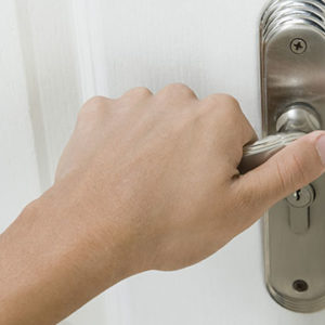 person holding a door handle