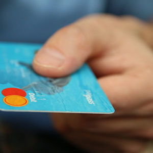 person holding mastercard credit card